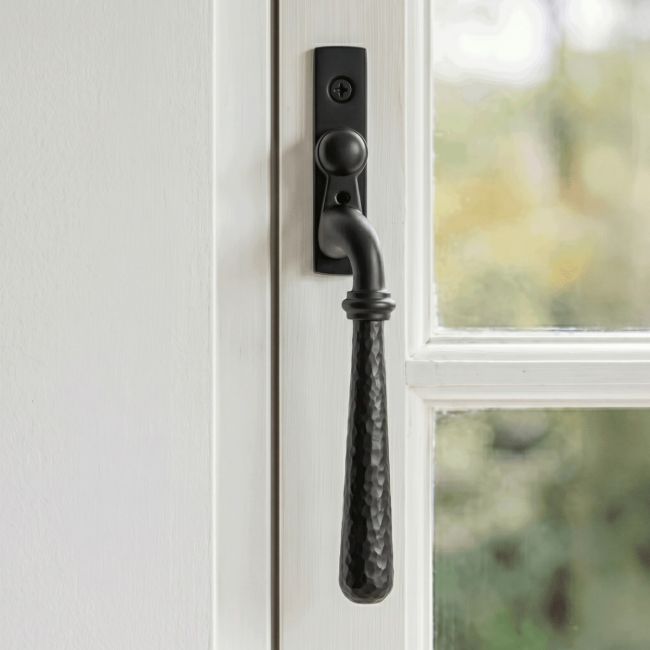 The Left Handed Dark Aged Bronze Hammered Espag Window Handle Mounted on a Traditional White Window Frame in a Country Home - Digital Illustration 