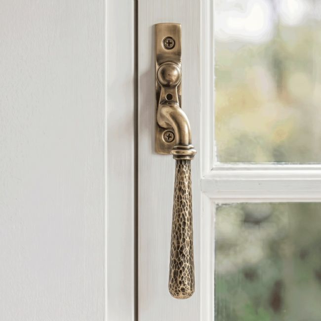 The Right Handed Polished Bronze Hammered Espag Window Handle on a Hand painted White Window Frame - Digital Illustration