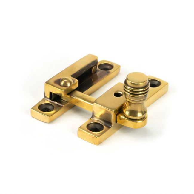 The Rimmed Narrow Quadrant Sash Fastener - Aged Brass on a White Background 