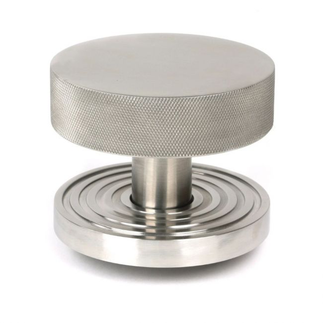 The Satin Stainless Steel Knurled Centre Door Knob on a Beehive Rose Shown Upright on a White Background The Satin Stainless Steel Knurled Centre Door Knob on a Beehive Rose Shown Upright on a White Background