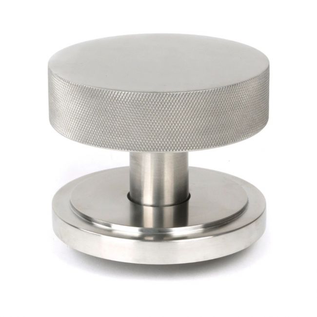 The Satin Stainless Steel Knurled Centre Door Knob on an Art Deco Rose Shown Upright on a White Background The Satin Stainless Steel Knurled Centre Door Knob on an Art Deco Rose Shown Upright on a White Background