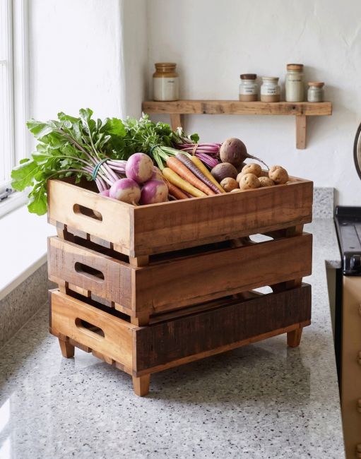 The set of Three Reclaimed Wood Vegetable Trays Holding a Selection of Root Vegetables in a Country Kitchen - Digital Illustration