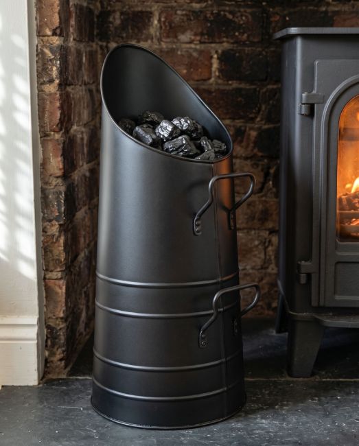 The Sleek Black Coal Hod in a Modern Home with a Lit Log Burner behind - Digital Illustration The Sleek Black Coal Hod in a Modern Home with a Lit Log Burner behind - Digital Illustration