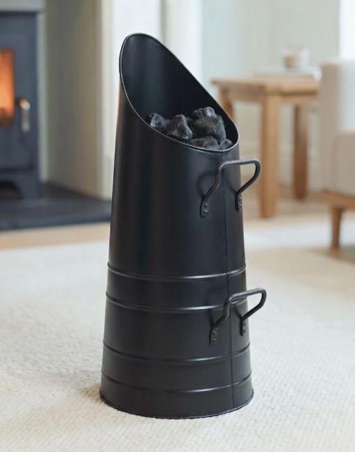 The Sleek Black Coal Hod in a Modern Home with a Lit Log Burner behind - Digital Illustration The Sleek Black Coal Hod in a Modern Home with a Lit Log Burner behind - Digital Illustration