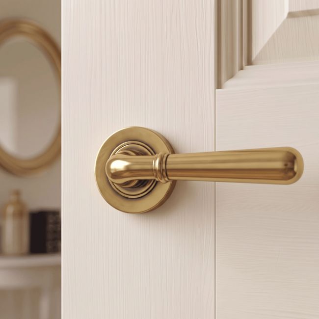 The Slender Classic Reeded Lever on Plain Rose Set - Aged Brass on a White Background 
