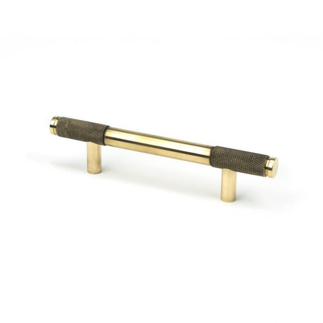 The Small Half Knurled Cabinet Pull Handle in Aged Brass Shown Upright on a White Background The Small Half Knurled Cabinet Pull Handle in Aged Brass Shown Upright on a White Background