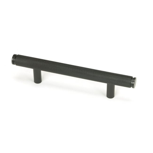 The Small Knurled Cabinet Pull Handle in Aged Bronze Shown Upright on a White Background