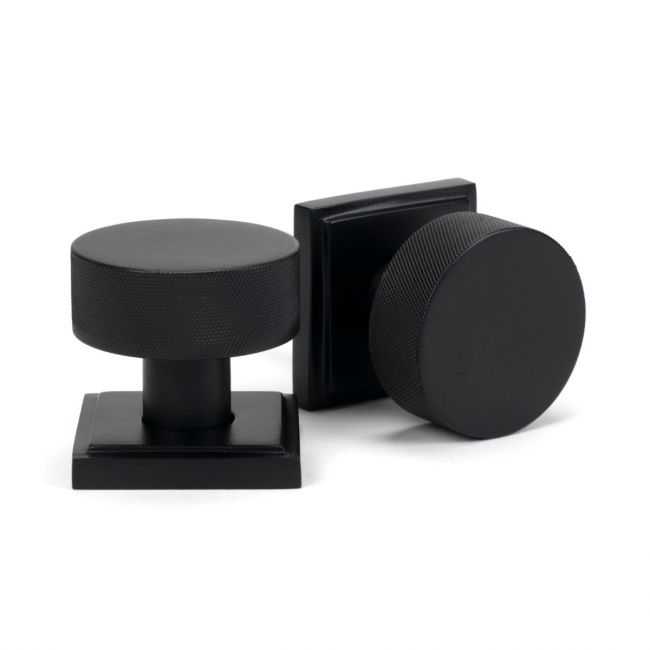 The Knurled Mortice/Rim Knob Set on a Square Rose in Matt Black Shown Upright on a White Background The Knurled Mortice/Rim Knob Set on a Square Rose in Matt Black Shown Upright on a White Background