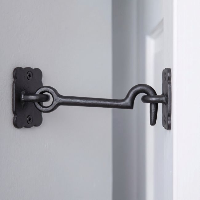 The Traditional Black Iron 3" Loose Ring Cabin Hook in a Modern Home on a White Door - Digital Illustration