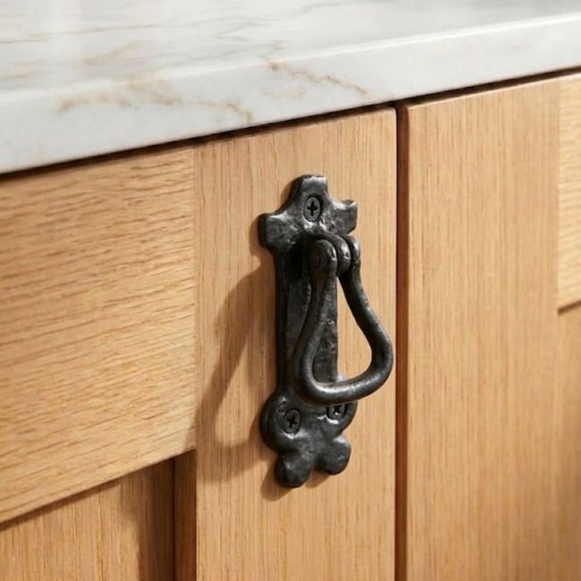 The Traditional Black Iron Drop Cabinet Looped Pull Handle Mounted on a Contemporary Wooden Kitchen Cabinet - Digital Illustration 