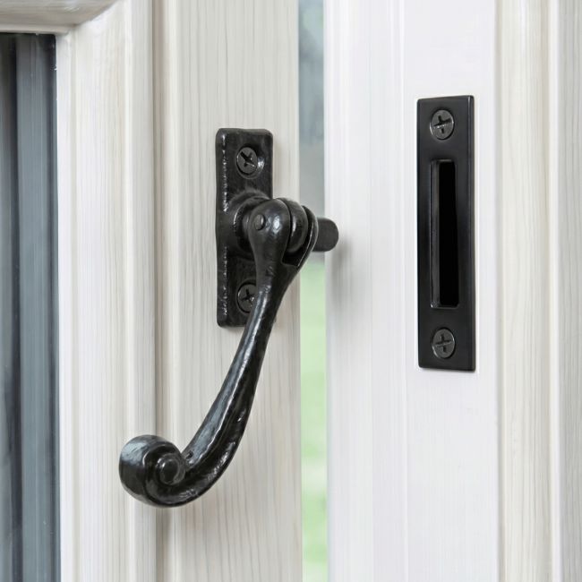 The Traditional Black Iron Window Casement Stay With Mortice Plate Mounted on a White Window Frame - Digital Illustration The Traditional Black Iron Window Casement Stay With Mortice Plate Mounted on a White Window Frame - Digital Illustration