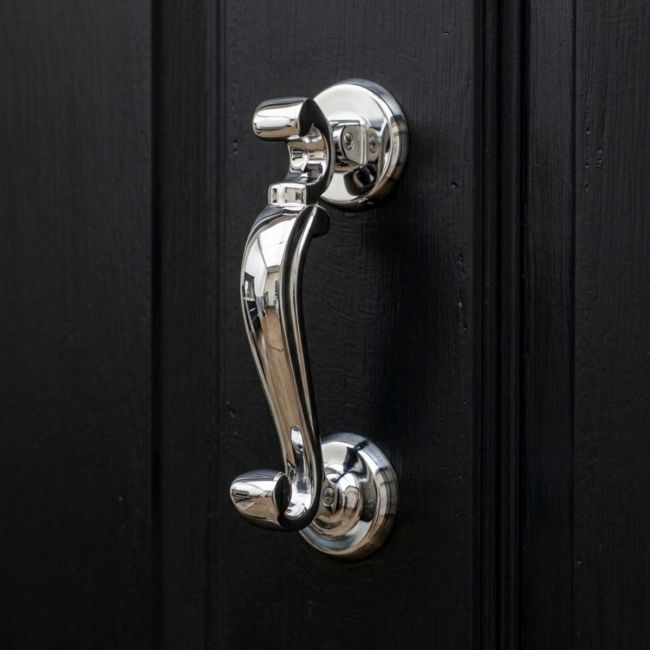 The Traditional Doctor"s Door Knocker Polished Stainless Steel Shown on its Side on a White Background
