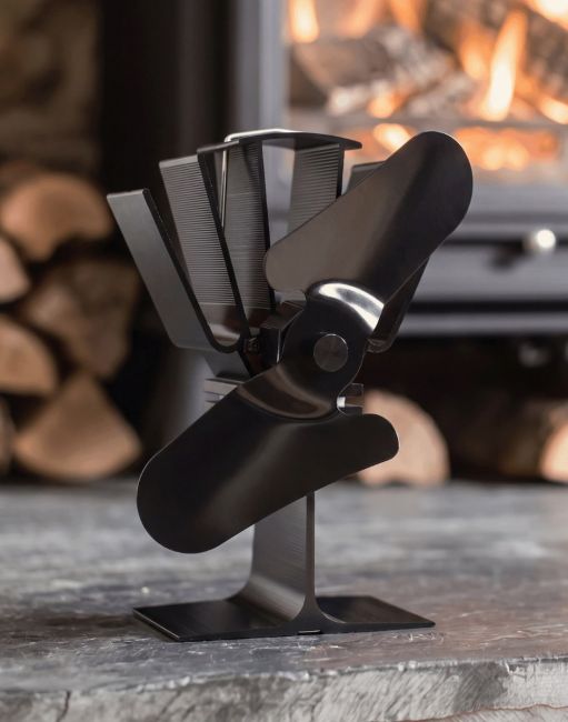 The Two Blade Heat Powered Stove Fan Displayed in Front of a Black Metal Log Burner Stove - Digital Illustration The Two Blade Heat Powered Stove Fan Displayed in Front of a Black Metal Log Burner Stove - Digital Illustration