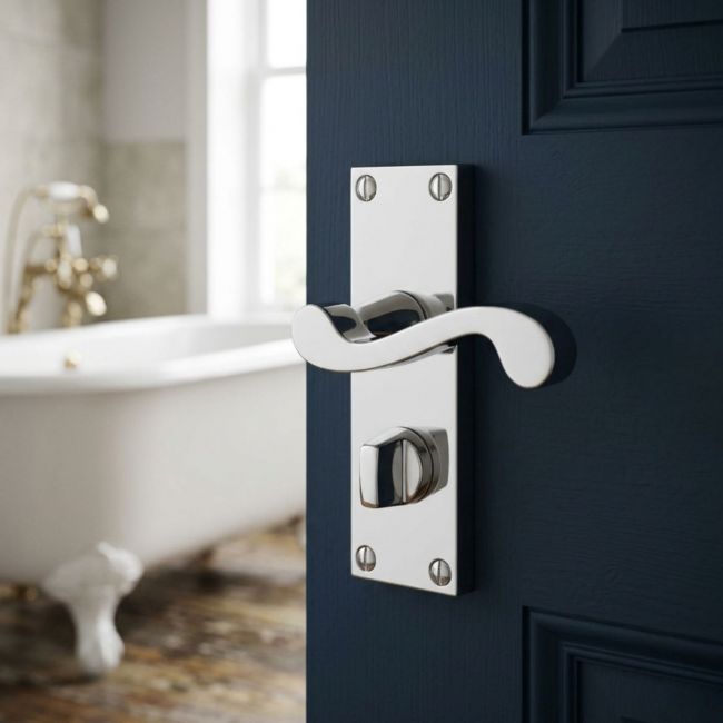 The Polished Chrome Victorian Scroll Bathroom Door Handles - Lever Lock Pair with Thumb Turn on a White Background