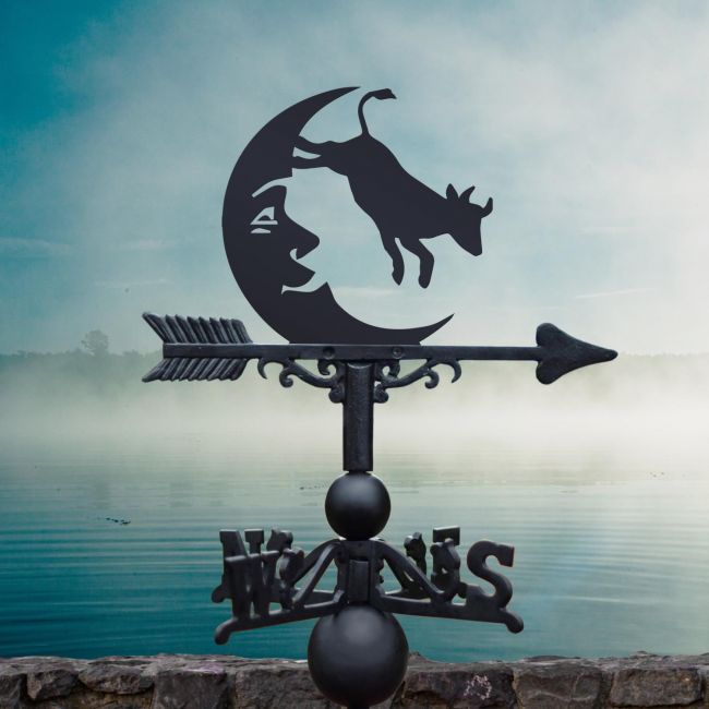 Cow Jumping over the moon weathervane in garden Cow Jumping over the moon weathervane in garden