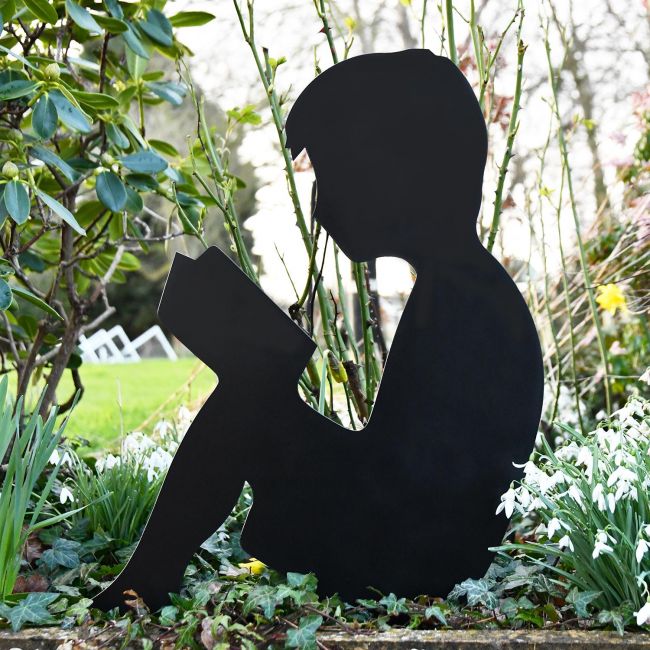 Metal Boy Reading Silhouette in situ in The Garden Metal Boy Reading Silhouette in situ in The Garden