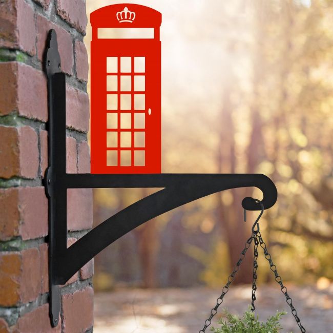 Red Telephone Box Hanging Basket Bracket on a Brick Wall in the Garden Red Telephone Box Hanging Basket Bracket on a Brick Wall in the Garden