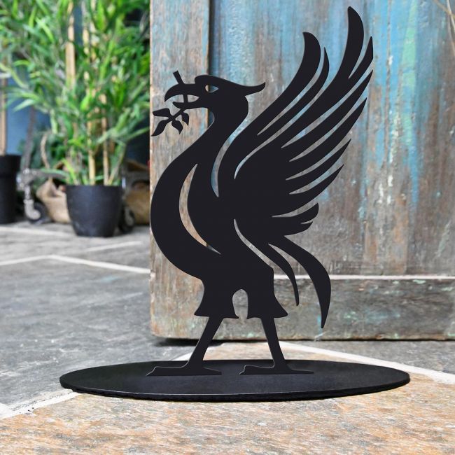 Liver Bird Iron Door Stop Next to a Rustic Blue Door Liver Bird Iron Door Stop Next to a Rustic Blue Door