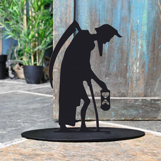 Old Father Time Iron Door Stop Next to a Rustic Blue Door Old Father Time Iron Door Stop Next to a Rustic Blue Door