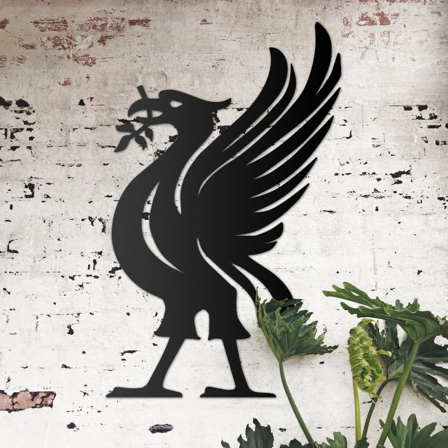 Liver Bird Wall Art on the Wall Next to Plants on a Rustic Wall Liver Bird Wall Art on the Wall Next to Plants on a Rustic Wall