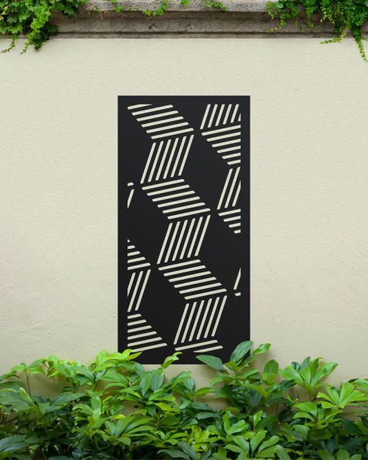 Black "Geometric Cube Wall Art" on a cream coloured garden wall surrounded by garden plants Black "Geometric Cube Wall Art" on a cream coloured garden wall surrounded by garden plants