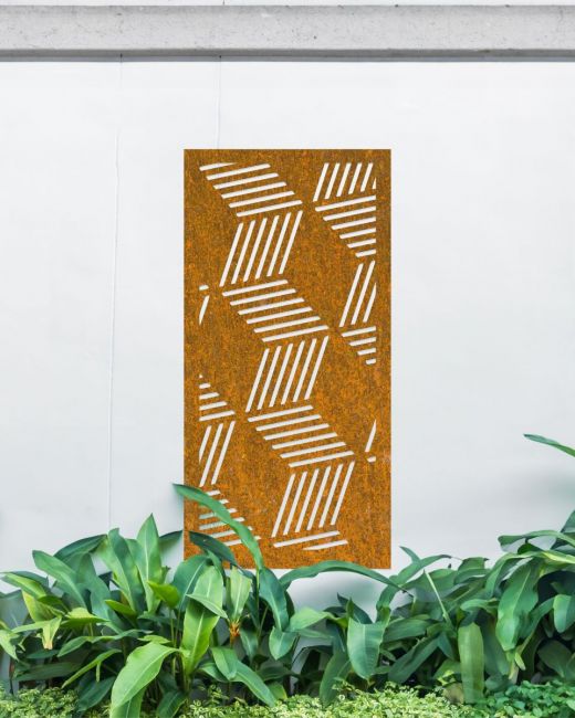 Rustic "Geometric Cube Wall Art" on a white garden wall behind garden plants Rustic "Geometric Cube Wall Art" on a white garden wall behind garden plants