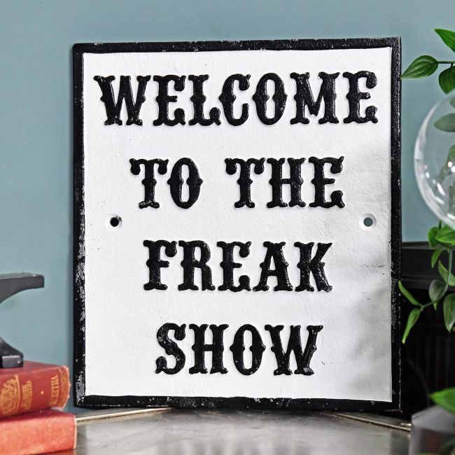 "Welcome To The Freak Show" Cast Iron Sign in Situ on a Blue Wall