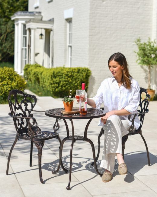 Woman Sat at Copper Garden Furniture Woman Sat at Copper Garden Furniture