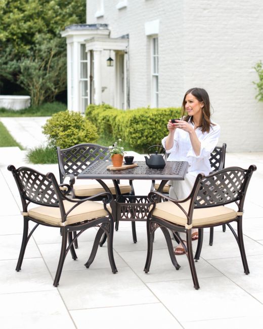 Woman Sat at Copper Garden Furniture Set Woman Sat at Copper Garden Furniture Set