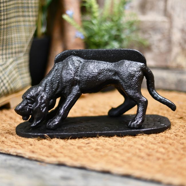 Cast iron boot scarper on door matt Cast iron boot scarper on door matt