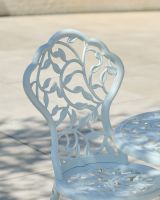 Close up of ornate vine pattern on chair backrest Close up of ornate vine pattern on chair backrest