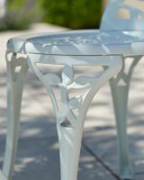 Close up of patterned chair leg detail on outdoor two seater table and chairs set Close up of patterned chair leg detail on outdoor two seater table and chairs set
