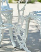 Close up of intricate table leg detail on patio table and chairs set