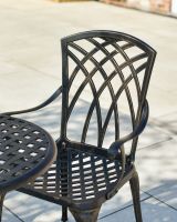 Close up of intricate on chair backrest on garden two seater table and chairs set Close up of intricate on chair backrest on garden two seater table and chairs set