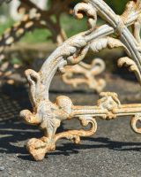 Close up of ornate side detail on cast iron outdoor bench