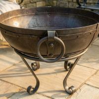 Digital Illustration of the 60cm Version of the Iron Kadai Bowl Fully Lit in Front of Rustic Garden Furniture Handle Close Up Digital Illustration of the 60cm Version of the Iron Kadai Bowl Fully Lit in Front of Rustic Garden Furniture Handle Close Up