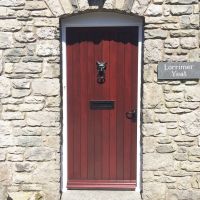 Fox head door knocker on wooden cottage door