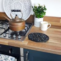 Black oval heavy duty trivet in kitchen