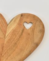 Close up of heart cut out detail on natural wood serving platter