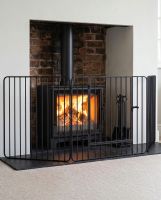 "Freyja" Heavy Duty Fire Guard With Door in Situ Next to the Fireplace Digital illustration