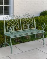 "Belvedere" Wrought Iron Garden Bench in front of hedge