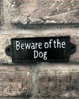 "Beware of the Dog" Traditional Cast Iron Wall Sign mounted on a brick wall