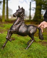 "Blaze" the Galloping Horse Cast Aluminium Garden Sculpture with hand in shot for scale