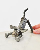 "Bolt" Stretching Puppy UpCycled Home Ornament with hand in shot for scale