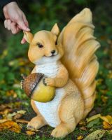 "Caper" the Handpainted Fibreglass Squirrel Garden Sculpture with hand in shot for scale
