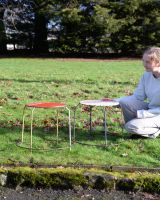 ‘Cask’ Set of 2 Upcycled Oil Drum Stools with lady crouching next to them for scale