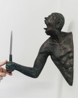 "Edge" Cast Aluminium Wall Art in Verdigris Finish with hand in shot for scale