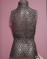 "Elora" Female Back Torso Reclaimed Metal Wall Sculpture mounted on wall with hand in shot for reference