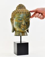 "Emerald Serenity" Buddha Head Ornament in Cast Brass with hand in shot for scale