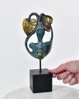 "Flora"s Whisper" Cast Brass Interior Ornament with hand in shot for scale